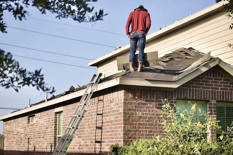 Professional roofer working on a residential roof in Greater Groves